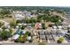 An aerial view of single-Gathering homes and community streets surrounded by lush trees at 31 Cedar St, Haines City, FL 33844