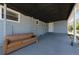 Spacious covered back porch with concrete flooring and exterior access at 31 Cedar St, Haines City, FL 33844