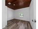 Bedroom featuring wood-look flooring and a unique wood plank ceiling at 31 Cedar St, Haines City, FL 33844