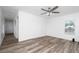 Spacious bedroom with wood-look floors, ceiling fan, and natural light from a window at 31 Cedar St, Haines City, FL 33844