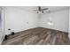 View of a bedroom with wood-look floors, a ceiling fan, and ample natural light from the window at 31 Cedar St, Haines City, FL 33844