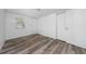 Bright bedroom features wood-look flooring, a window, and a closet at 31 Cedar St, Haines City, FL 33844