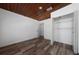 Bedroom showcasing wood-look floors, wooden ceiling, and a closet for storage at 31 Cedar St, Haines City, FL 33844
