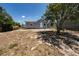 Exterior shot of a charming blue-gray cottage with a fenced yard at 31 Cedar St, Haines City, FL 33844