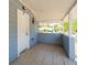 View of a covered porch with tile flooring and light blue accents, leading to the home's front door at 31 Cedar St, Haines City, FL 33844