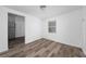 Room featuring wood-look floors and a window offering natural light at 31 Cedar St, Haines City, FL 33844