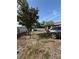 Spacious backyard with partial fence, mature tree, and ample open area, and parked SUV at 311 Congress Ave, Auburndale, FL 33823