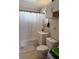 Tiled full bathroom featuring shower/tub, standard toilet, vanity and white shower curtain at 311 Congress Ave, Auburndale, FL 33823