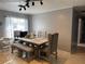 Bright dining room features a large table and chairs set on neutral tile flooring at 311 Congress Ave, Auburndale, FL 33823