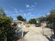 Long driveway with white picket fence, parked truck, shed and partial gate in the foreground at 311 Congress Ave, Auburndale, FL 33823
