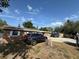 A brick home with dark trim and white trim and a vehicle parked in the driveway at 311 Congress Ave, Auburndale, FL 33823