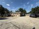 The house has a concrete driveway, neutral paint color and white trim around the windows at 311 Congress Ave, Auburndale, FL 33823
