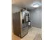 The kitchen features stainless steel appliances and neutral tile flooring at 311 Congress Ave, Auburndale, FL 33823