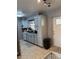 The kitchen has gray walls, tile flooring, and white cabinets at 311 Congress Ave, Auburndale, FL 33823