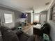 Inviting living room features gray walls, dark floors and plenty of space for Gathering at 311 Congress Ave, Auburndale, FL 33823