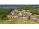 Aerial view of a waterfront apartment complex, surrounded by trees and golf course at 3235 Candle Ridge Dr # 102, Orlando, FL 32822