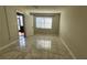 Bright, airy bedroom featuring marble tile flooring and a window allowing natural light at 3235 Candle Ridge Dr # 102, Orlando, FL 32822