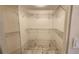 Walk-in closet featuring updated marble tile flooring and wire rack shelving at 3235 Candle Ridge Dr # 102, Orlando, FL 32822
