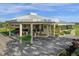 Exterior view of a beautifully landscaped clubhouse with a covered entrance, wreaths and lovely landscaping at 3235 Candle Ridge Dr # 102, Orlando, FL 32822