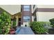 Condo entrance with lush landscaping and a well-maintained walkway at 3235 Candle Ridge Dr # 102, Orlando, FL 32822