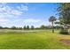 Scenic golf course view with lush green grass and mature trees, perfect for a day on the greens at 3235 Candle Ridge Dr # 102, Orlando, FL 32822