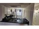 Kitchen with black countertops, stainless steel appliances, and view to eat-in space at 3235 Candle Ridge Dr # 102, Orlando, FL 32822