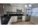 Kitchen with stainless steel appliances, white cabinets, and tile flooring at 3235 Candle Ridge Dr # 102, Orlando, FL 32822