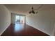Living room with wood floors and sliding glass doors to the lanai at 3235 Candle Ridge Dr # 102, Orlando, FL 32822