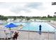 Community pool with many lounge chairs surrounding a refreshing pool and scenic views at 3235 Candle Ridge Dr # 102, Orlando, FL 32822