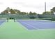 Outdoor tennis court with well-maintained green and blue surface, ready for a match at 3235 Candle Ridge Dr # 102, Orlando, FL 32822