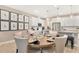 A dining area with white accent walls, modern lighting, and views into the kitchen at 331 Alexandrite St, Deland, FL 32720