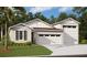 A charming new home with a three-car garage, lush lawn, and beautiful landscaping creates great curb appeal at 331 Alexandrite St, Deland, FL 32720