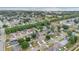 An aerial view of a subdivision on a sunny day; a body of water is visible in the background at 3886 Creek Bed Cir, St Cloud, FL 34769