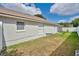 View of backyard with lush grass, a privacy fence and the home's exterior at 3886 Creek Bed Cir, St Cloud, FL 34769