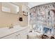Bright bathroom featuring a vanity, toilet, mirror, and novelty shower curtain at 3886 Creek Bed Cir, St Cloud, FL 34769