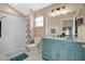 Stylish bathroom featuring a vanity with ample storage, a well-lit mirror, and a walk-in shower at 3886 Creek Bed Cir, St Cloud, FL 34769