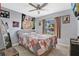 Cozy bedroom featuring a ceiling fan, a comfortable bed, and a window with natural light at 3886 Creek Bed Cir, St Cloud, FL 34769