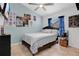 Comfortable bedroom with cool wall decor, a ceiling fan, and a cozy bed at 3886 Creek Bed Cir, St Cloud, FL 34769