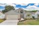 Charming home featuring brick accents, manicured landscaping, and an inviting entrance with an arched window at 3886 Creek Bed Cir, St Cloud, FL 34769