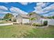 A well-maintained front yard featuring lush green grass, decorative landscaping, and charming curb appeal at 3886 Creek Bed Cir, St Cloud, FL 34769