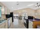 Modern kitchen featuring updated appliances and a view of the dining area and pool through sliding doors at 3886 Creek Bed Cir, St Cloud, FL 34769