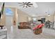 Open concept living room boasts a large arched window, vaulted ceilings, and a comfortable sectional sofa at 3886 Creek Bed Cir, St Cloud, FL 34769