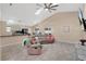 Bright and airy living room with tile floors, vaulted ceilings, and comfortable furnishings at 3886 Creek Bed Cir, St Cloud, FL 34769