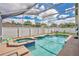 Inviting screened-in pool area with a hot tub, perfect for relaxation and entertainment at 3886 Creek Bed Cir, St Cloud, FL 34769
