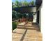 Inviting back patio with a wooden deck, offering a comfortable outdoor living space at 4385 Ne 2Nd Ct, Ocala, FL 34479