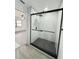 Bathroom with a large walk-in shower featuring decorative tiled walls and floors at 4385 Ne 2Nd Ct, Ocala, FL 34479