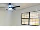 Bedroom features a black ceiling fan and updated window with a view of the outdoors at 4385 Ne 2Nd Ct, Ocala, FL 34479