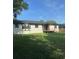 Exterior view of home with backyard wooden deck, dark framed windows, and green lawn at 4385 Ne 2Nd Ct, Ocala, FL 34479