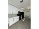 Modern kitchen featuring sleek white cabinets, updated countertops, and stainless steel appliances at 4385 Ne 2Nd Ct, Ocala, FL 34479