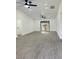 Bright living room featuring sleek gray flooring and modern ceiling fans, leading to a patio at 4385 Ne 2Nd Ct, Ocala, FL 34479